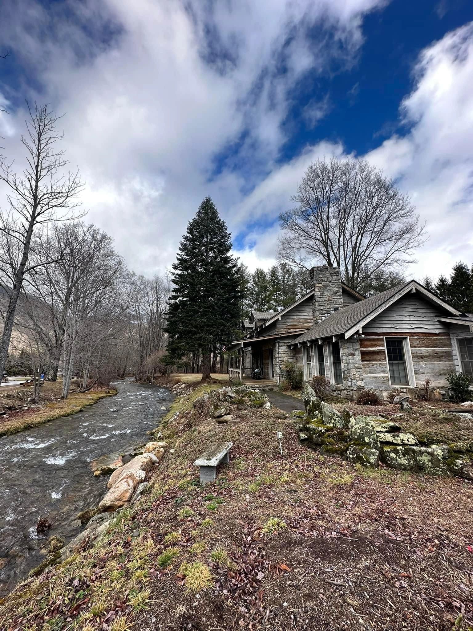 Campbell Creek running past a Pioneer Village cabin